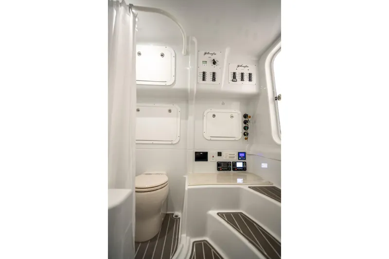  Yacht Photos Pics 2025 Yellowfin 42 Offshore boat interior with modern bathroom and control panels.
