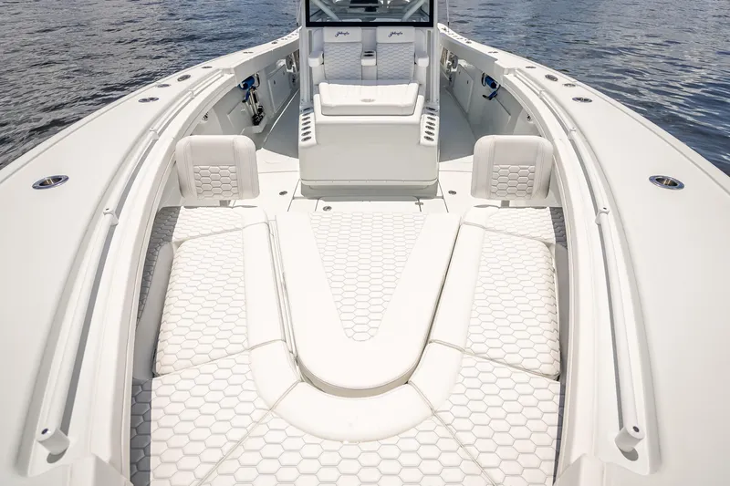  Yacht Photos Pics 2025 Yellowfin 42 Offshore boat interior with white seating and hexagonal pattern design.