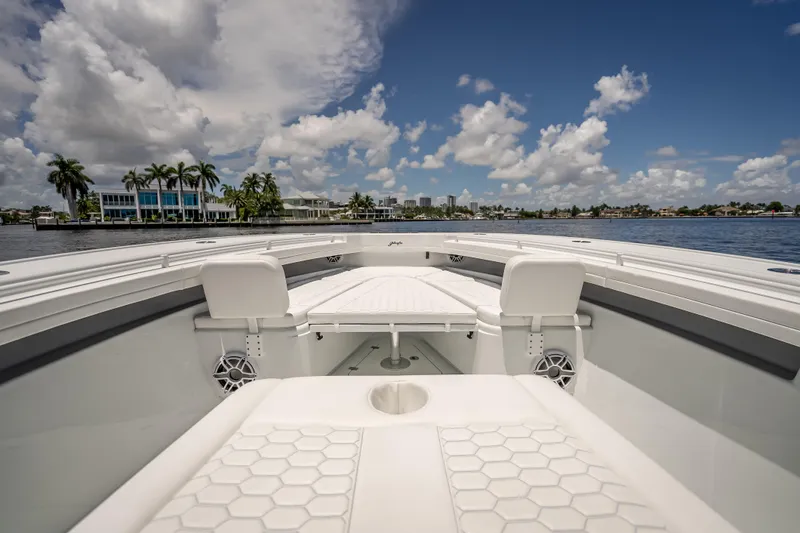  Yacht Photos Pics 2025 Yellowfin 42 Offshore boat interior with seating, on a sunny day by the water.