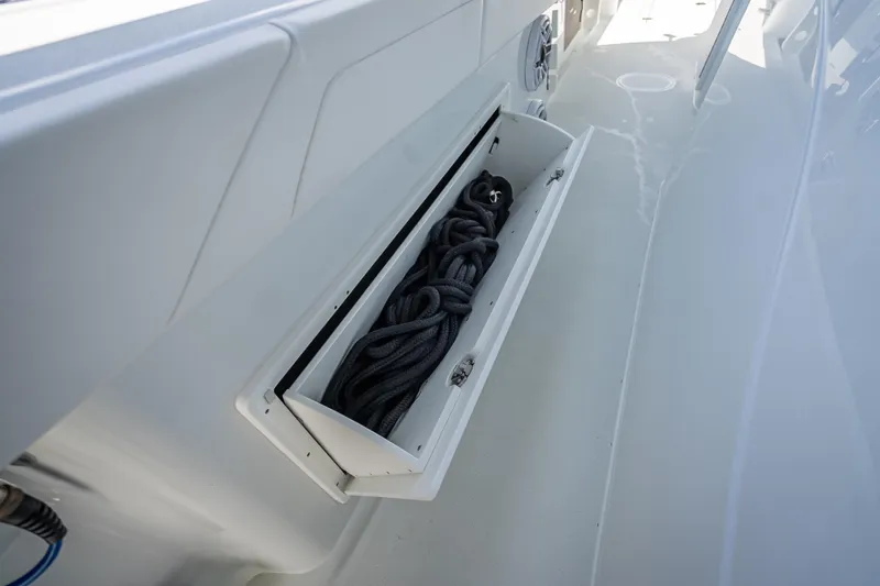  Yacht Photos Pics 2025 Yellowfin 42 Offshore boat storage compartment with coiled rope.