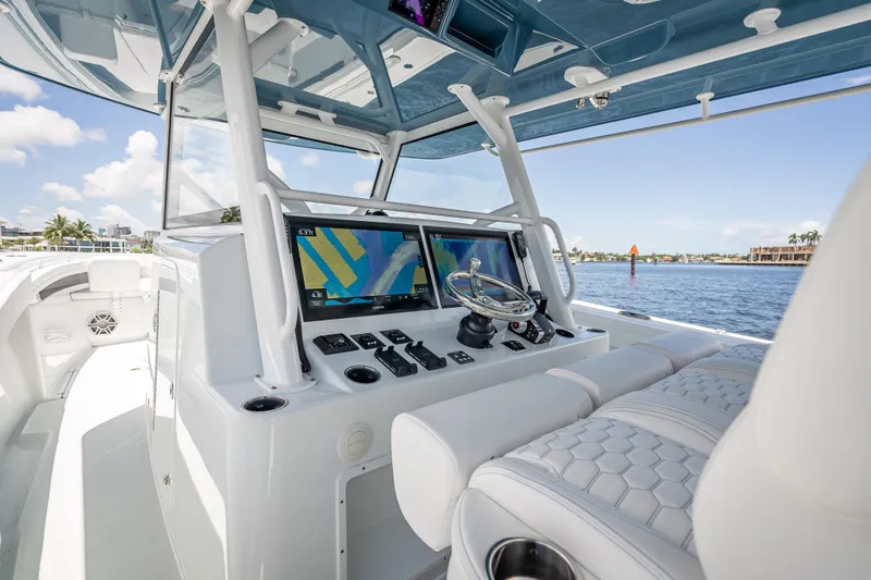  Yacht Photos Pics 2025 Yellowfin 42 Offshore boat cockpit with advanced navigation system and luxurious seating.