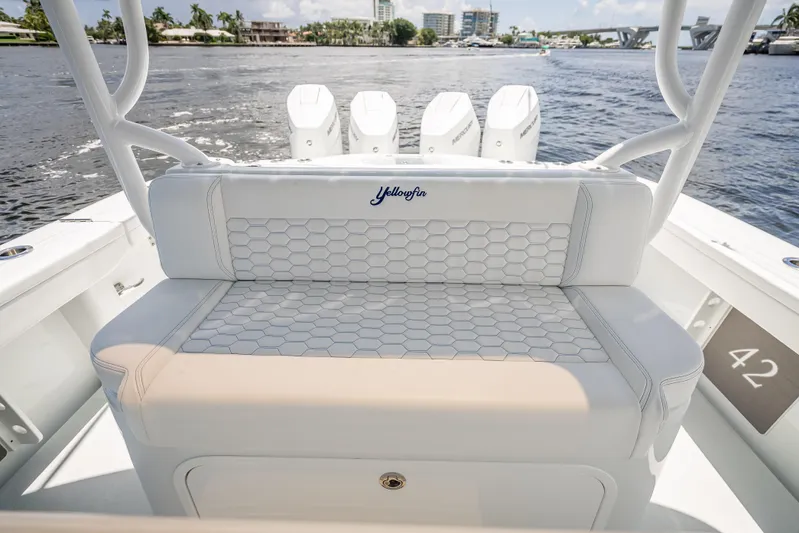 Yacht Photos Pics 2025 Yellowfin 42 Offshore boat interior with hexagonal-patterned seating and multiple outboard engines.