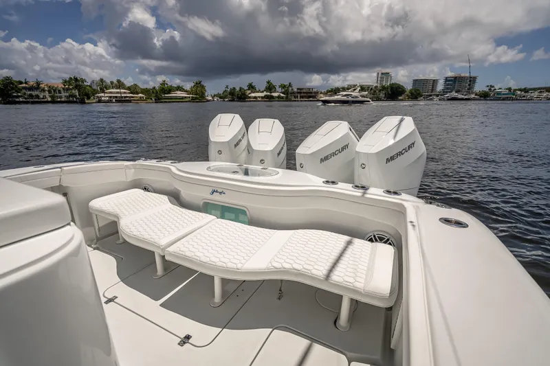  Yacht Photos Pics 2025 Yellowfin 42 Offshore boat with Mercury engines on a calm waterway.