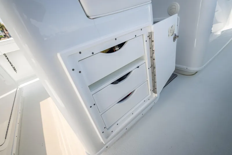  Yacht Photos Pics 2025 Yellowfin 42 Offshore boat storage compartment with open door and drawers.