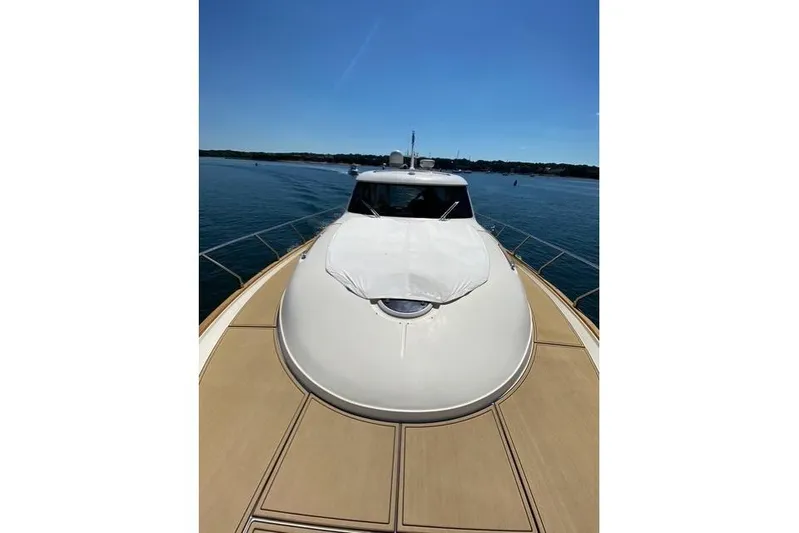 Pallavisino Yacht Photos Pics 2007 Mochi Craft 44 Dolphin yacht on calm water, showcasing sleek design and spacious deck.