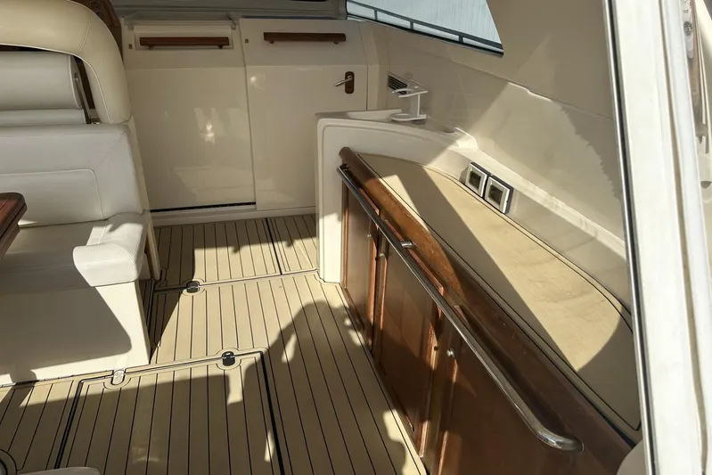 Pallavisino Yacht Photos Pics Interior of 2007 Mochi Craft 44 Dolphin yacht with elegant seating and wooden accents.