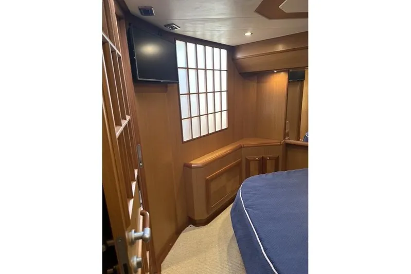 Pallavisino Yacht Photos Pics Interior of 2007 Mochi Craft 44 Dolphin yacht, featuring wood paneling and a mounted TV.