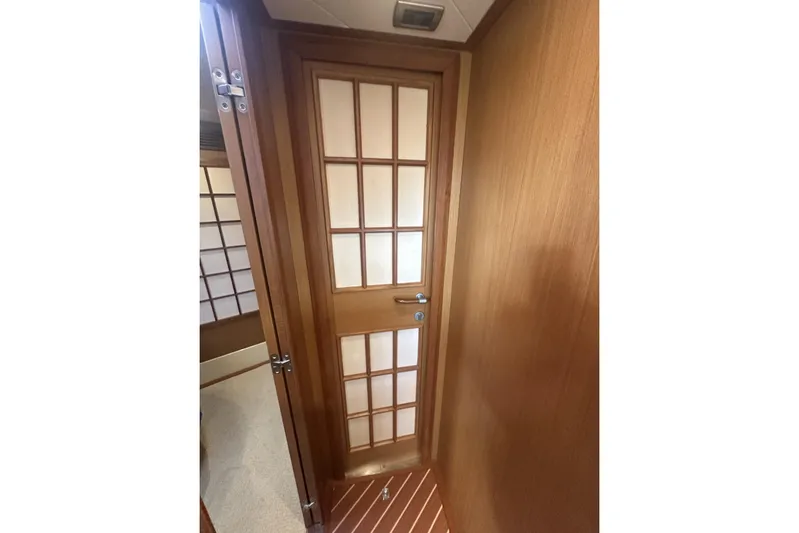 Pallavisino Yacht Photos Pics Interior of 2007 Mochi Craft 44 Dolphin yacht with wooden door and paneling.