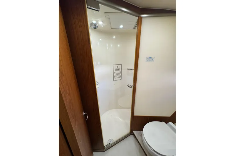  Yacht Photos Pics Bathroom interior of 2007 Tiara 43 yacht with glass shower door and modern fixtures.