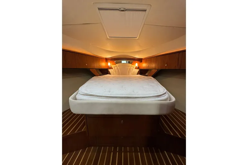 Yacht Photos Pics Luxurious cabin interior of 2007 Tiara 43 yacht with cozy bed and wooden accents.