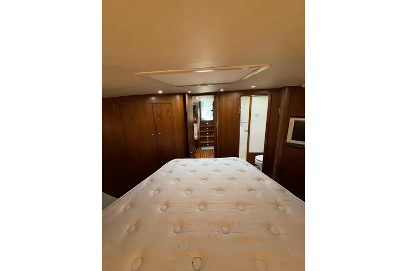  Yacht Photos Pics Luxurious cabin interior of 2007 Tiara 43 yacht with wood paneling and cozy bed.