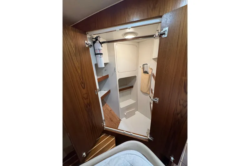  Yacht Photos Pics Interior of 2007 Tiara 43 yacht with wooden door and storage shelves.