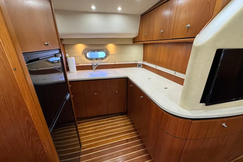  Yacht Photos Pics Luxurious 2007 Tiara 43 yacht kitchen with wood cabinetry and modern appliances.