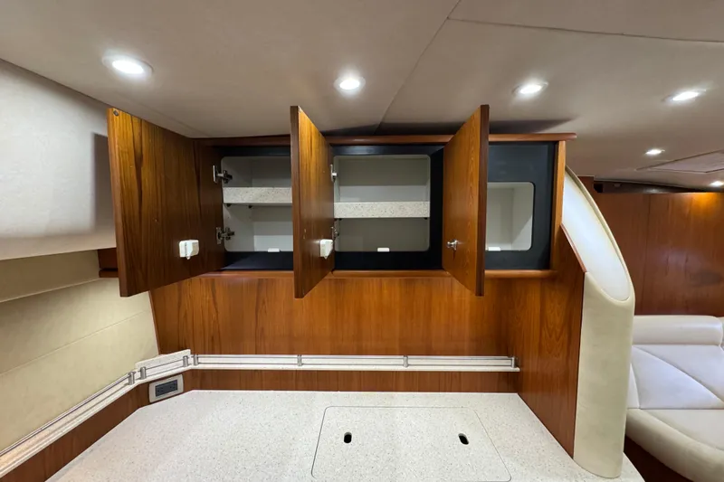  Yacht Photos Pics Open wooden cabinets in a 2007 Tiara 43 yacht interior with modern lighting.