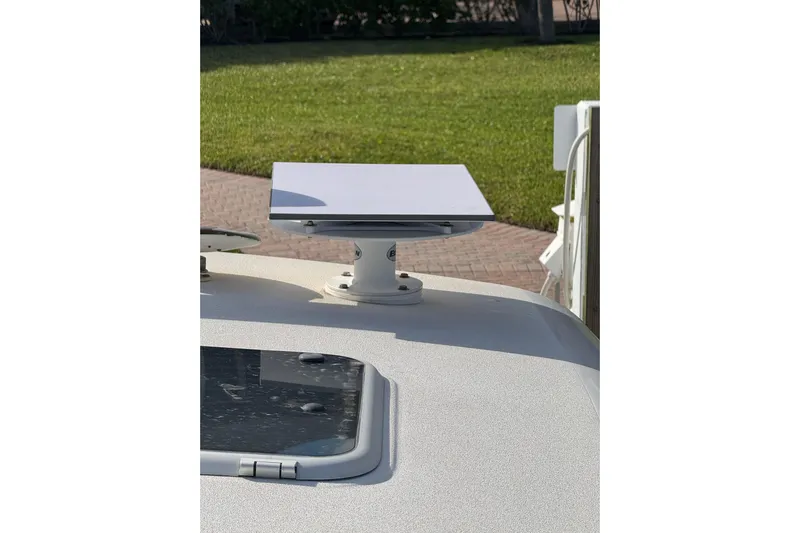  Yacht Photos Pics Satellite dish mounted on a 2007 Tiara 43 boat, with a grassy background.