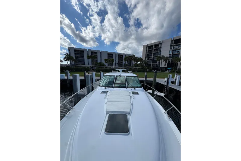  Yacht Photos Pics 2007 Tiara 43 yacht docked with modern buildings and cloudy sky in background.