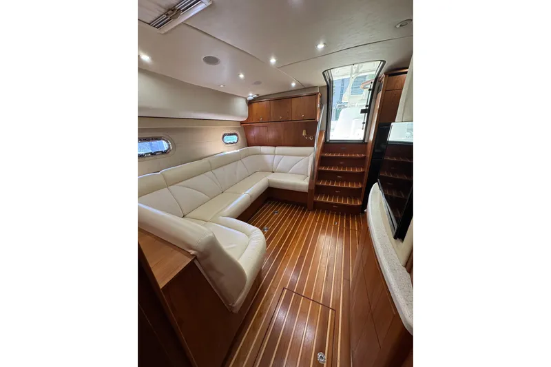  Yacht Photos Pics Luxurious interior of 2007 Tiara 43 yacht with elegant wood flooring and plush seating.