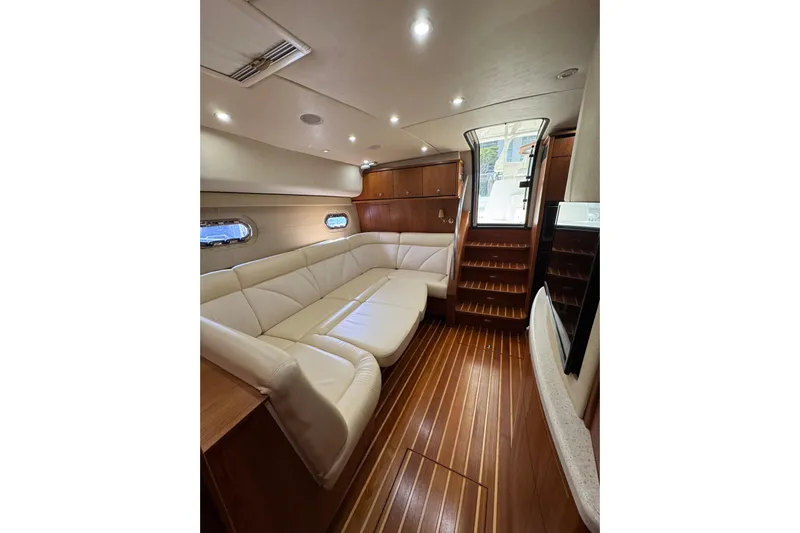  Yacht Photos Pics Luxurious interior of a 2007 Tiara 43 yacht with elegant wood flooring and plush seating.