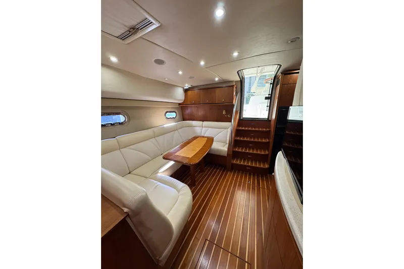 Yacht Photos Pics Luxurious interior of a 2007 Tiara 43 yacht with elegant wood finishes and plush seating.