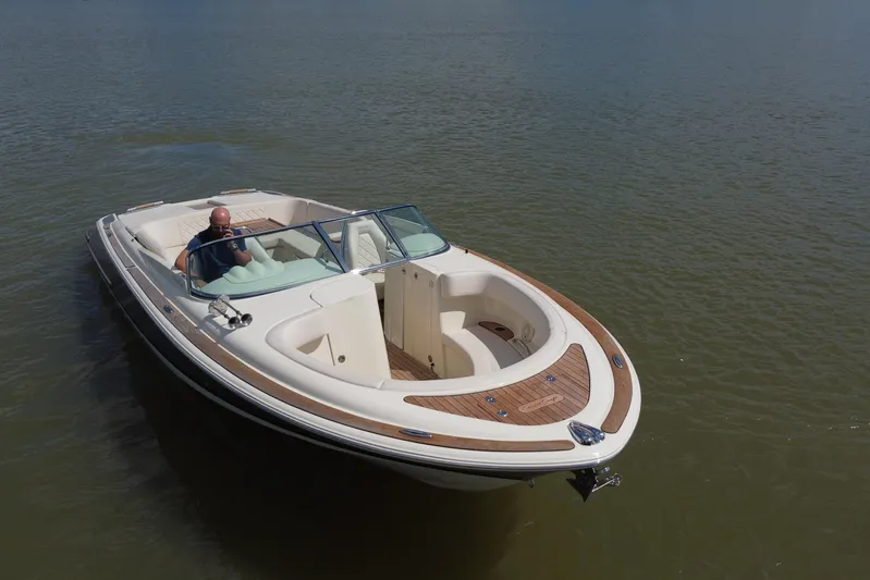  Yacht Photos Pics 2019 Chris-Craft Launch 30 boat on calm water, featuring elegant design and spacious seating.