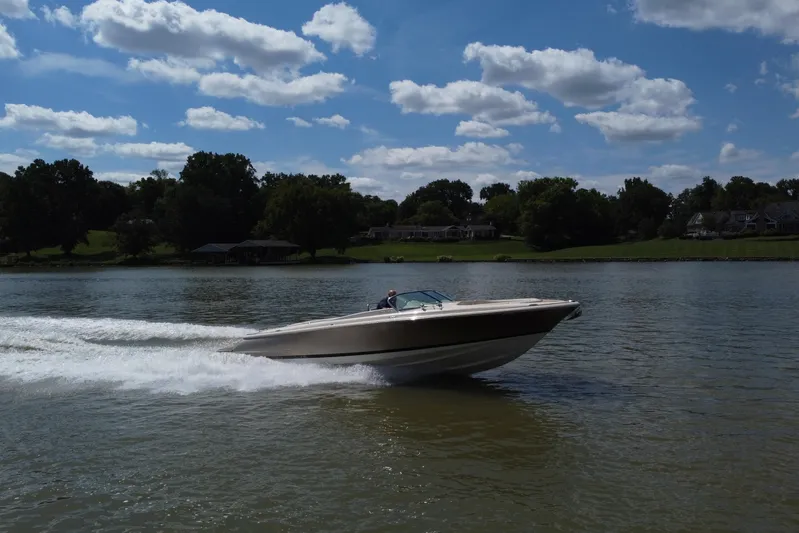  Yacht Photos Pics 2019 Chris-Craft Launch 30 speeding on a lake under a partly cloudy sky.