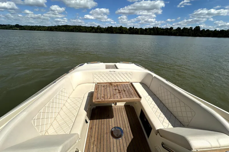  Yacht Photos Pics 2019 Chris-Craft Launch 30 boat interior with elegant seating and wooden table on a lake.