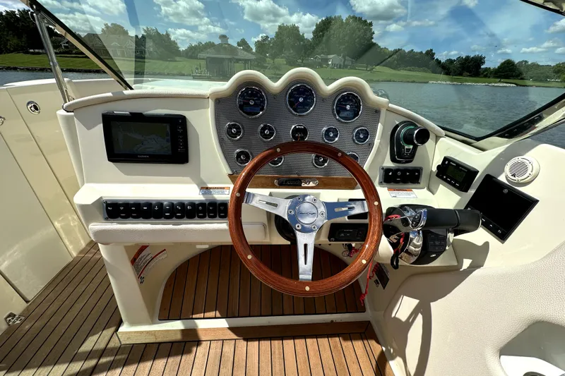  Yacht Photos Pics 2019 Chris-Craft Launch 30 dashboard with wooden steering wheel and navigation system.