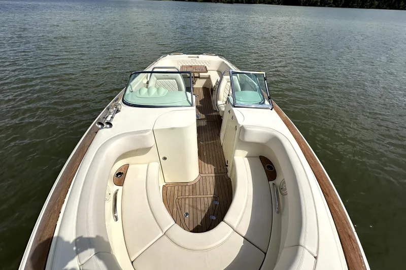  Yacht Photos Pics 2019 Chris-Craft Launch 30 boat with elegant seating and wooden deck on calm water.