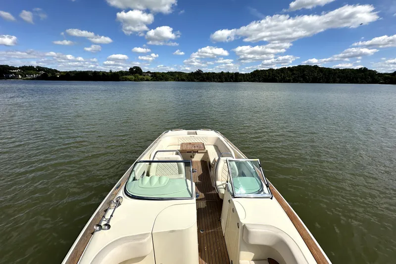  Yacht Photos Pics 2019 Chris-Craft Launch 30 on serene lake under blue sky with clouds.