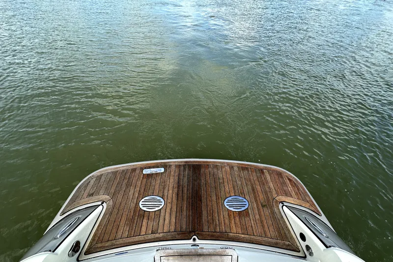  Yacht Photos Pics 2019 Chris-Craft Launch 30 boat with wooden deck on calm water.