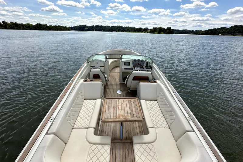  Yacht Photos Pics 2019 Chris-Craft Launch 30 boat on a serene lake with clear skies.