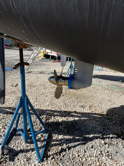 Ikati Yacht Photos Pics Propeller and rudder of 2011 Leopard 39 catamaran on stands, gravel ground.