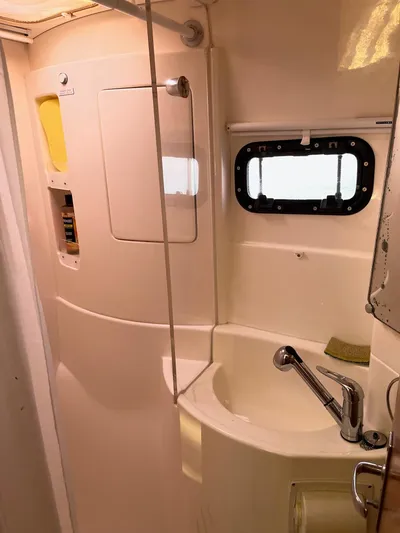 Ikati Yacht Photos Pics Compact bathroom in 2011 Leopard 39 yacht with sink, mirror, and porthole window.