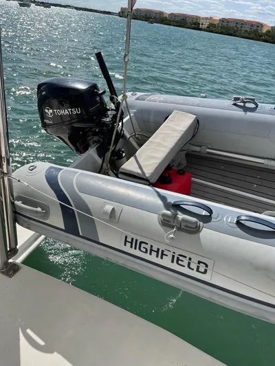 Ikati Yacht Photos Pics Inflatable boat with Tohatsu motor on Leopard 39, 2011 model, docked on calm water.