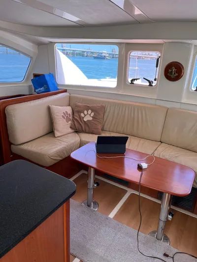 Ikati Yacht Photos Pics Interior of 2011 Leopard 39 yacht with beige seating and wooden table.