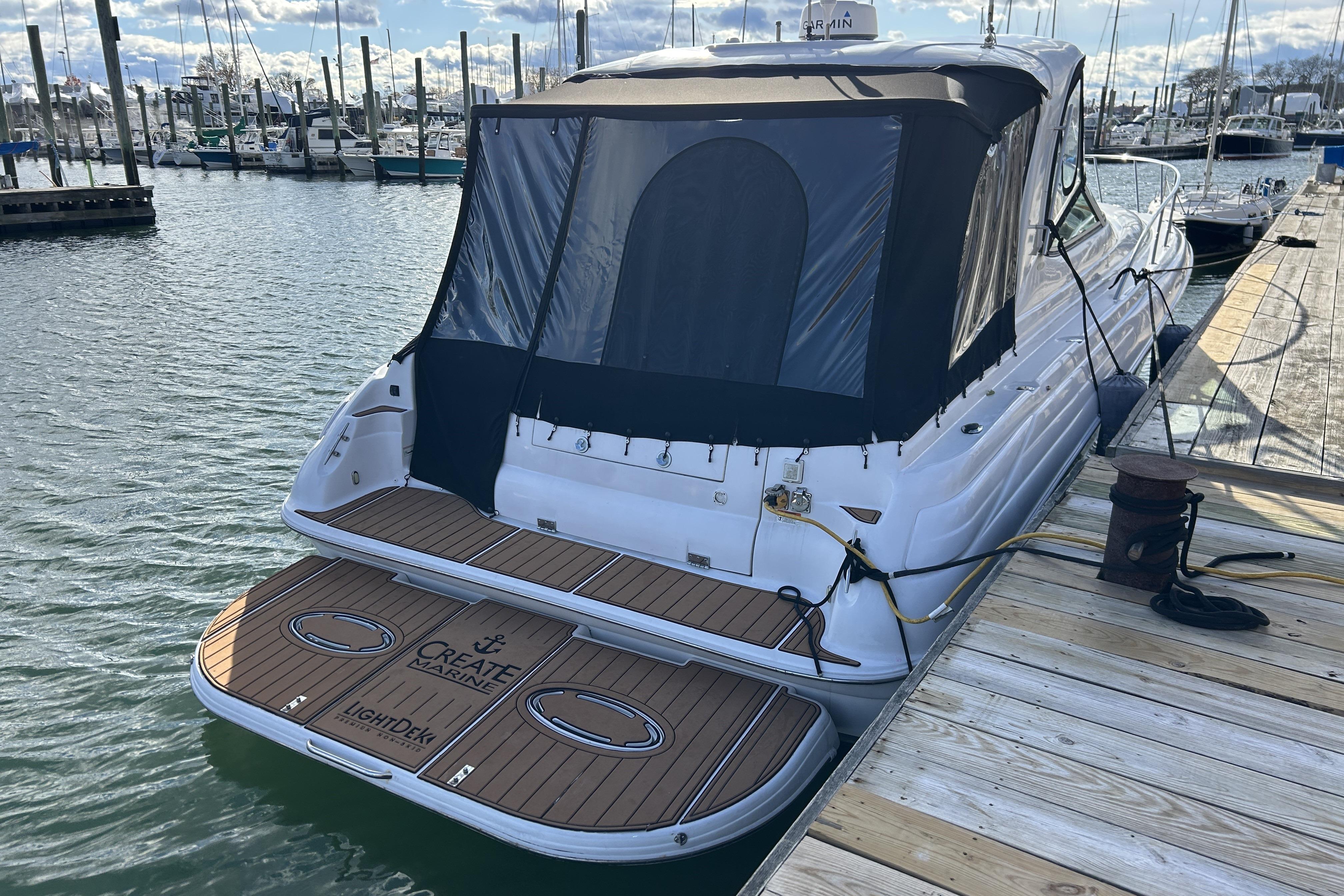 2007 Larson 370 Cabrio yacht docked at marina with covered deck.