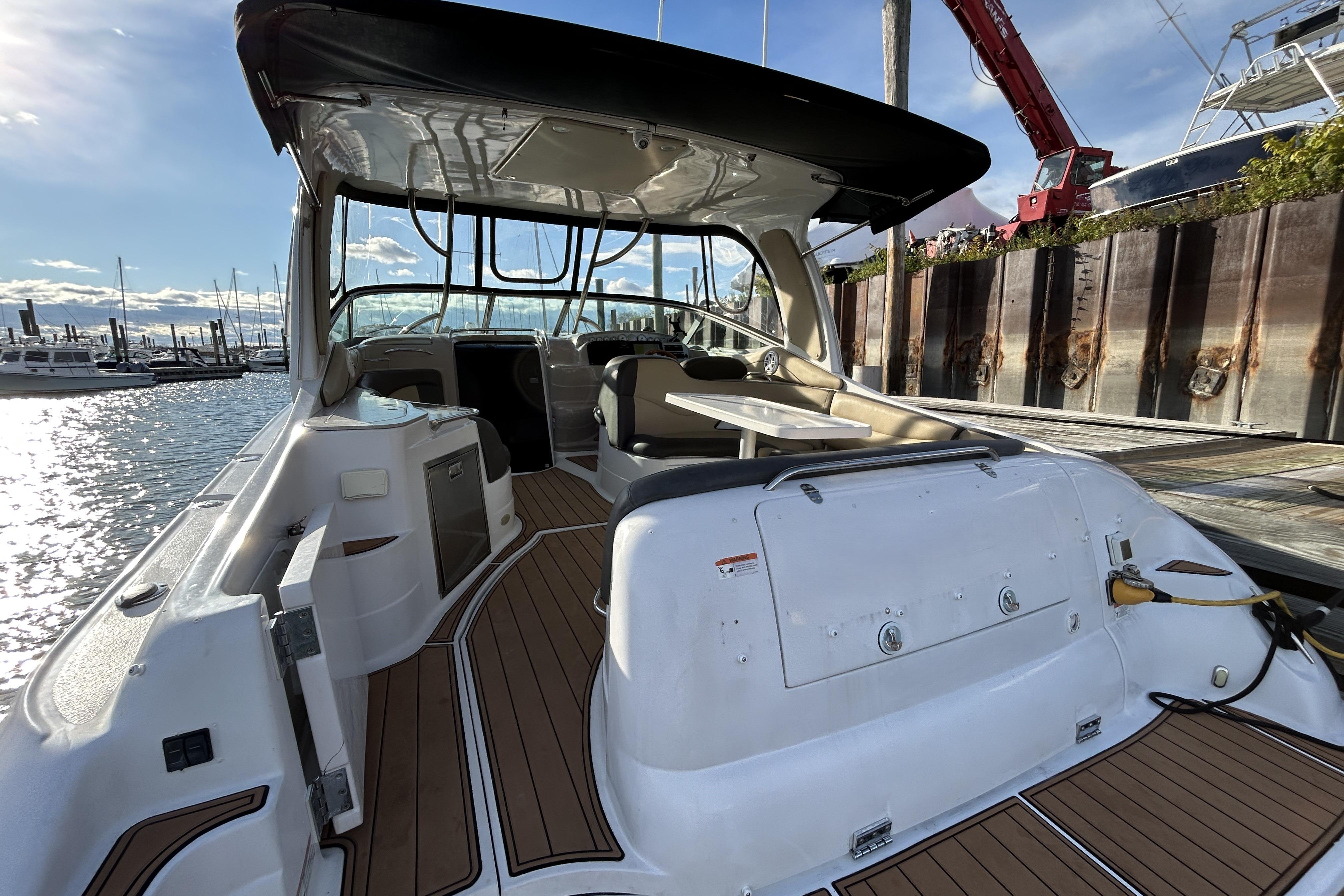 2007 Larson 370 Cabrio boat interior with seating and table, docked at marina.