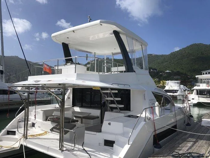 Rockin U Yacht Photos Pics 2020 Leopard 43 Powercat yacht docked at marina with scenic mountain backdrop.