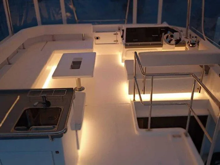 Rockin U Yacht Photos Pics Interior of 2020 Leopard 43 Powercat with modern seating, table, and ambient lighting.