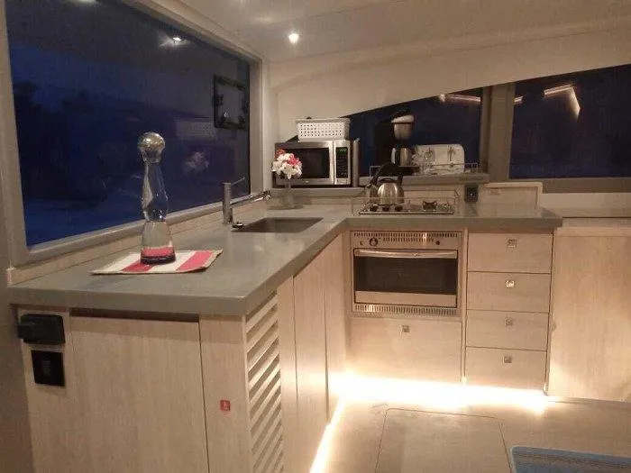 Rockin U Yacht Photos Pics Modern kitchen interior on 2020 Leopard 43 Powercat yacht with sleek countertops and appliances.