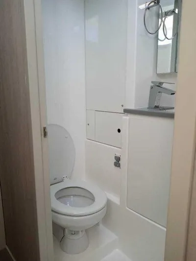 Rockin U Yacht Photos Pics Compact bathroom in a 2020 Leopard 43 Powercat, featuring a modern toilet and sink.