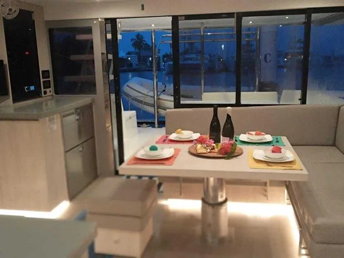 Rockin U Yacht Photos Pics Interior of 2020 Leopard 43 Powercat yacht with elegant dining setup and modern furnishings.