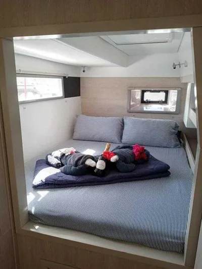 Rockin U Yacht Photos Pics Cozy cabin interior of 2020 Leopard 43 Powercat with plush bedding and stuffed animals.