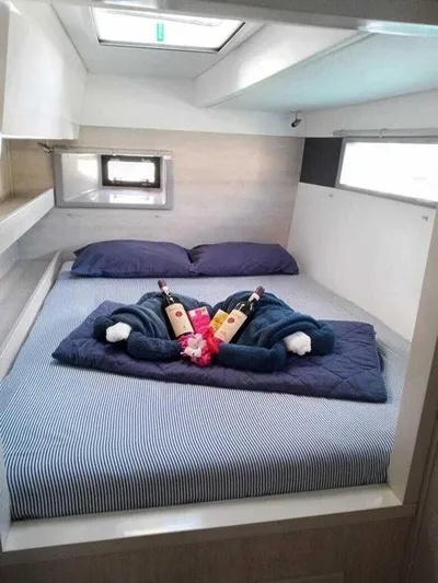 Rockin U Yacht Photos Pics Cozy cabin interior of 2020 Leopard 43 Powercat with bed, wine, and towels.