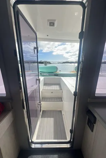 Rockin U Yacht Photos Pics Leopard 43 Powercat 2020 yacht interior with open door leading to deck and ocean view.