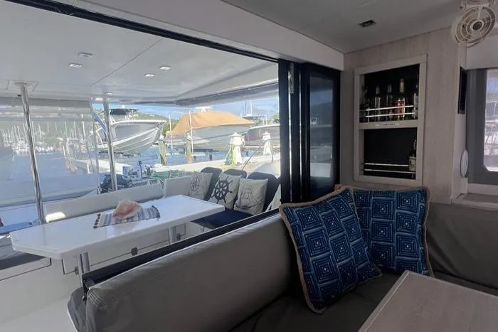 Rockin U Yacht Photos Pics Interior of 2020 Leopard 43 Powercat with seating, table, and marina view.
