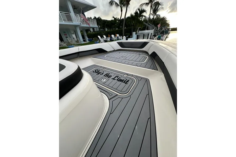  Yacht Photos Pics 2021 ShearWater 270 Carolina Flare boat deck with "Sky's the Limit" text, docked near palm trees.