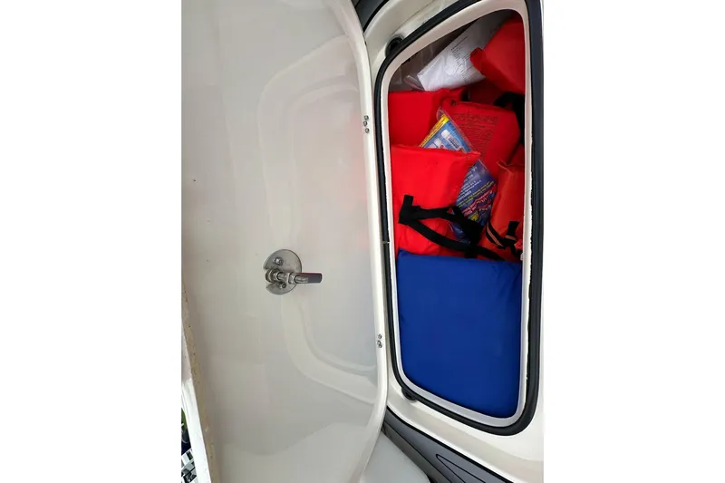  Yacht Photos Pics Storage compartment with life jackets on a 2021 ShearWater 270 Carolina Flare boat.
