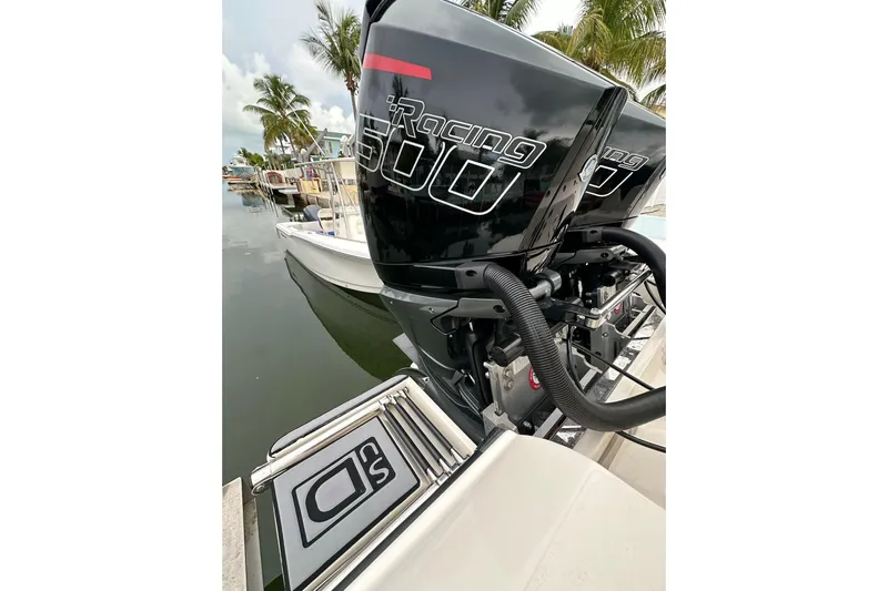  Yacht Photos Pics 2021 ShearWater 270 Carolina Flare boat with powerful racing engines docked by palm trees.