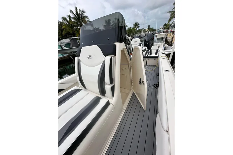  Yacht Photos Pics 2021 ShearWater 270 Carolina Flare boat interior with sleek seating and open storage compartment.